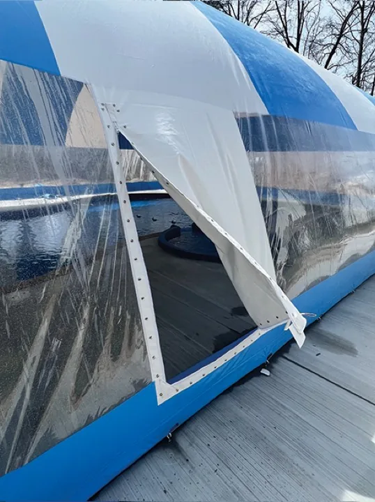 Zippered entry panel on a pool dome enclosure unzipped and folded back for entry