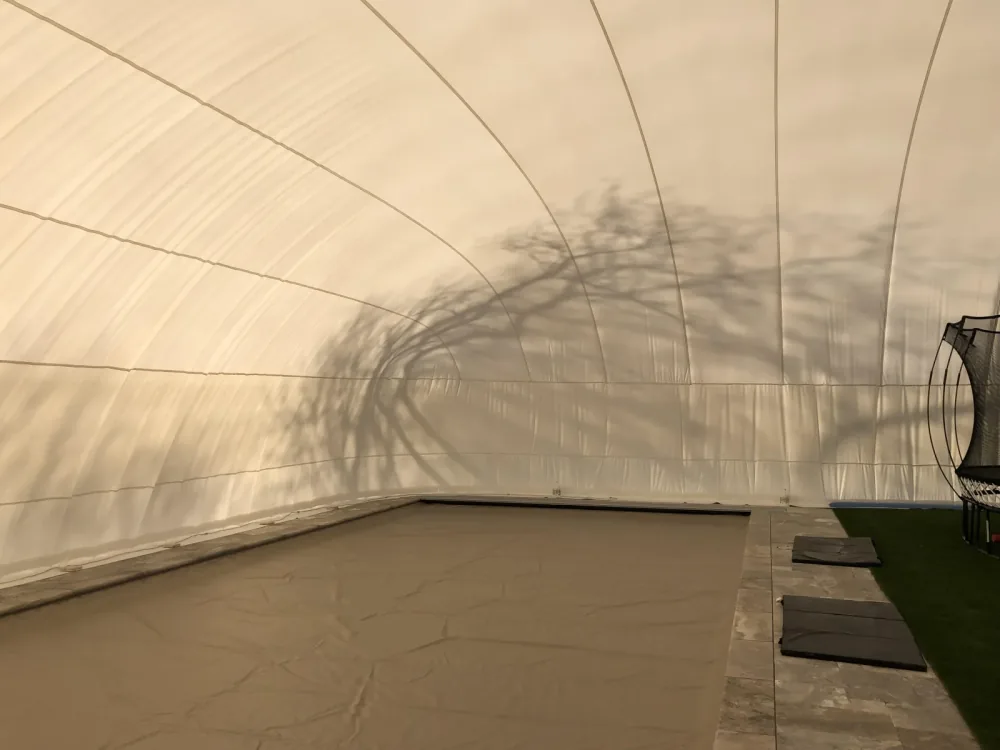 Inside a dome enclosing both a covered pool and an area of artificial turf